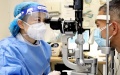 A chief physician of ophthalmology department conducts examination for a patient in Shanghai Tenth People's Hospital in east China's Shanghai. Photo by Xinhua/Chen Jianli.
