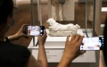 Visitors take photos of an exhibit at the Hong Kong Palace Museum in Hong Kong, south China. Photo by Xinhua/Wang Shen.