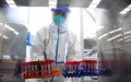 A staff member transfers samples for nucleic acid test at an inflatable COVID-19 testing lab in Shunyi District of Beijing. Photo by Xinhua/Ren Chao.