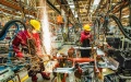 Workers weld at a factory of an automobile manufacturing enterprise in Qingzhou City, east China's Shandong Province. Photo by Wang Jilin/Xinhua.