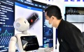An attendee interacts with a robot. Photo by Xinhua/Guo Xulei.