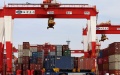 A truck carrying containers is seen at the container dock of Shanghai's Yangshan Port in east China. Photo by Xinhua/Chen Jianli.