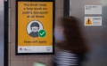 A mask-on notice is seen at a train station in Sydney, Australia. Photo by Hu Jingchen/Xinhua.