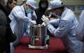 Scientific researchers transfer the container loaded with moon samples retrieved by the Chang'e-5 probe in Beijing, capital of China. Photo by Xinhua/Jin Liwang.