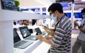 Visitors get to know laptops at the World Computer Conference in Changsha, Hunan Province in Central China. Photo by Xinhua.
