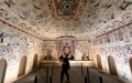 A visitor takes photos of exhibits at an exhibition themed on Dunhuang culture at the Palace Museum, also known as the Forbidden City, in Beijing, capital of China. Photo by Xinhua/Li Xin.