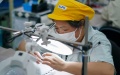 A worker is busy at an electronic switch production and assembly workshop of a subsidiary of Alps Alpine in Wuxi, east China's Jiangsu Province. Photo by Xinhua/Li Bo.