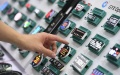 A visitor touches nixie tube screens at the 10th China Information Technology Expo in Shenzhen, south China's Guangdong Province. Photo by Xinhua/Mao Siqian.