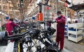 Employees work on a truck assembly line at a factory for the vehicle manufacturing company Jianghuai Automobile Group Corp. (JAC) in Qingzhou in eastern China's Shandong province. Photo by Xinhua.