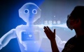 A staff member introduces a promotion video of 5G AI technology at the exhibition center of the national big data (Guizhou) comprehensive pilot zone in southwest China's Guizhou Province. Photo by Xinhua/Ou Dongqu.