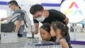 Children look at an intelligent mechanical arm at the main venue of 2022 national mass entrepreneurship and innovation week in Hefei, capital of east China's Anhui Province. Photo by Xinhua/Du Yu.