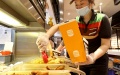 An employee packs food for an online order at a Burger King store in east China's Shanghai. Photo by Xinhua/Chen Jianli.