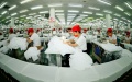 Workers make clothes for export at a company in Taihe County, east China's Anhui Province. Photo by Liang Xiaopeng/Xinhua.