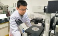 Wang Jizhuang, one of the leading researchers from Jinan University, uses a microscope to observe micro-robots removing microplastics and nanoplastics (MNPs) from water. Photo by Jinan University/Xinhua.