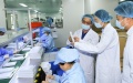 Head of a biotech company (3rd R) introduces a cosmetics production line to a market regulator and a bank staff member for loan application in Huzhou City, east China's Zhejiang Province. Photo by Xinhua/Weng Xinyang.