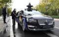 A woman takes a self-driving taxi at an appointed location on the Daoxianghu Road in Haidian District of Beijing, capital of China. Photo by Xinhua/Ren Chao.