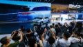 Visitors and press take photos of a car of BYD, China's new energy vehicle (NEV) manufacturer, at the Chengdu Motor Show. Photo by Xinhua/Shen Bohan.