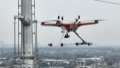 An unmanned drone with centimeter-level high-precision positioning capabilities inspects the automatic transmission lines of the electric transmission towers in east China's Jiangsu Province. Photo by Xinhua.