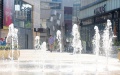 A citizen walks by a fountain amid high temperature in Minhang District of east China's Shanghai. Photo by Xinhua/Fang Zhe.