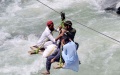 Local residents use a temporary cradle service to cross the river Swat after flash floods in Bahrain area of northwest Pakistan's Swat district on Sept. 5, 2022. Photo by Saeed Ahmad/Xinhua.