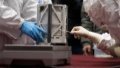 A staff member cleans up the surface of the container loaded with moon samples retrieved by the Chang'e-5 probe in Beijing, capital of China. Photo by Xinhua/Jin Liwang.