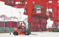 A worker operates a forklift at Yangshan Deep Water Port, one of Shanghai Port's main units. Photo by Xinhua.