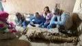 The archeological workers gathering around a mummy unearthed at an ancient family tomb in Luxor, Egypt. Photo by Egyptian Ministry of Tourism and Antiquities/ Xinhua.