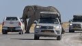 Tourists parking their vehicles to wait as an elephant walks across a road in the Etosha National Park in Namibia. Photo by Xinhua/Chen Cheng.
