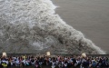 People gather to watch the Qiantang River tidal bore on the bank of the Qiantang River in Yanguan Town of Haining City, east China's Zhejiang Province. Photo by Xinhua/Han Chuanhao.