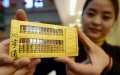 An employee displays a gold abacus in a gold jewellery shop in Jinan, capital of east China's Shandong Province. Photo by Xinhua/Zhao Xiaoming.