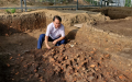 Fang Qin, head of Hubei provincial institute of cultural relics and archaeology, at the site of Shijiahe, the ruins of a prehistoric city in central China's Hubei Province. Photo by Xinhua.