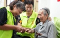 A volunteer helps a senior resident cut nail in Donghu District, Nanchang, east China's Jiangxi Province.  Photo by Xinhua/Peng Zhaozhi.