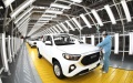 A worker inspects a vehicle before it rolls off the production line at an automobile manufacturing factory in Qingdao, east China's Shandong Province. Photo by Zhang Jingang/Xinhua.