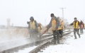 Staff members clear ice and snow along a railway track at Tongbei Railway Station in Beian, northeast China's Heilongjiang Province. Photo by Xinhua/Wang Song.