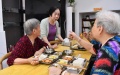 Party chief of the Junmen Community Lin Dan (2nd L) talks with senior residents at a community canteen at Junmen Community in Fuzhou, southeast China's Fujian Province. Photo by Xinhua/Jiang Kehong.