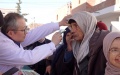 Hu Changrong, a member of the Chinese medical team to Tunisia, inspects eyes of an old man during a free clinical activity in Tunisia's northwestern province of El Kef. Photo by Xinhua/Xu Supei.