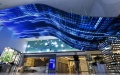 A staff member watches a video at the exhibition center of the national big data comprehensive pilot zone in southwest China's Guizhou Province. Photo by Xinhua/Ou Dongqu.