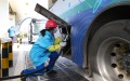 A staff member refuels a public bus at a hydrogen refueling station in Lingang new area of Pudong New Area in east China's Shanghai. Photo by Xinhua/Fang Zhe.