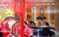 A customer tries gold jewelry at a store during the Mid-Autumn Festival holiday in Danzhai County, southwest China's Guizhou Province. Photo by Huang Xiaohai/Xinhua.