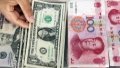 A teller picks a dollar bill among banknotes of U.S. dollar and Renminbi (RMB) at a bank in Linyi, east China's Shandong Province. Photo by Xinhua/Zhang Chunlei.

