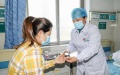 Nursing practitioner Zhang Zhiping (R) measures a patient's blood sugar level at the Workers' Hospital of Tengzhou, east China's Shandong Province. Photo by Song Haicun/Xinhua.

