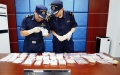 Staff members of customs check ivory products and red coral products seized in inbound parcels, in Taiyuan, north China's Shanxi Province. Photo by Ni Song/Xinhua.

