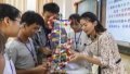 A teacher and students study a DNA structure model at a middle school in Xingye County, south China's Guangxi Zhuang Autonomous Region. Photo by Xinhua/Cao Yiming.
