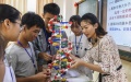 A teacher and students study a DNA structure model at a middle school in Xingye County, south China's Guangxi Zhuang Autonomous Region. Photo by Xinhua/Cao Yiming.