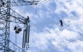 Workers operate on a power transmission tower in Yaodong Village of Xi'an, northwest China's Shaanxi Province. Photo by Dong Xiwei/Xinhua.