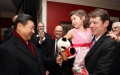Xi Jinping (L) presents the granddaughter of his old friend Sarah Lande with a panda doll in Muscatine, a small city in Iowa, the United States, Feb. 15, 2012. Photo by Xinhua/Lan Hongguang.