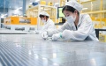Staff members work at a workshop of a photovoltaic technology company in Yancheng, east China's Jiangsu Province. Photo by Xinhua/Li Bo.