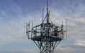 A staff member installing equipment on a 5G base station in northwest China's Xinjiang Uygur Autonomous Region. Photo by Xinhua.