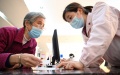 A staff member explains medical insurance policies to a resident at a hospital in Sanming, Fujian Province. Photo by Xinhua/Jiang Kehong.