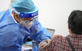 A medical worker injects a booster shot of COVID-19 vaccine for a resident at Aoyuncun Subdistrict in Chaoyang District, Beijing, capital of China. Photo by Xinhua/Ju Huanzong.